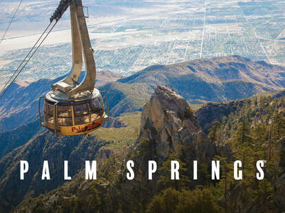 the aerial tramway over palm springs carries a car from the mountains down to the city of palm springs below
