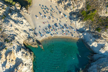 people enjoying the beach of ikari, greece