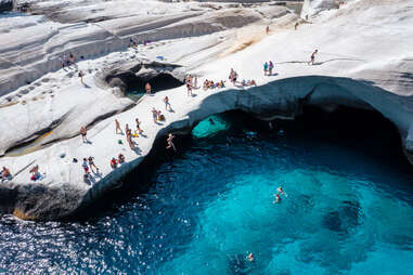 people enjoying sarakiniko beach, milos, greece