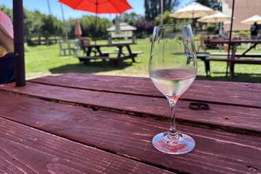 a glass of wine on a picnic table at parr collective