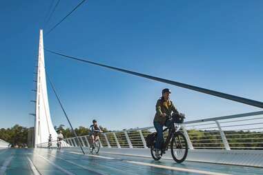 cyclist riding across sundial bridge in shasta cascade, california