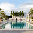 people walking by the pool at Arlo Wynwood