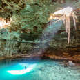 man swimming in cenote